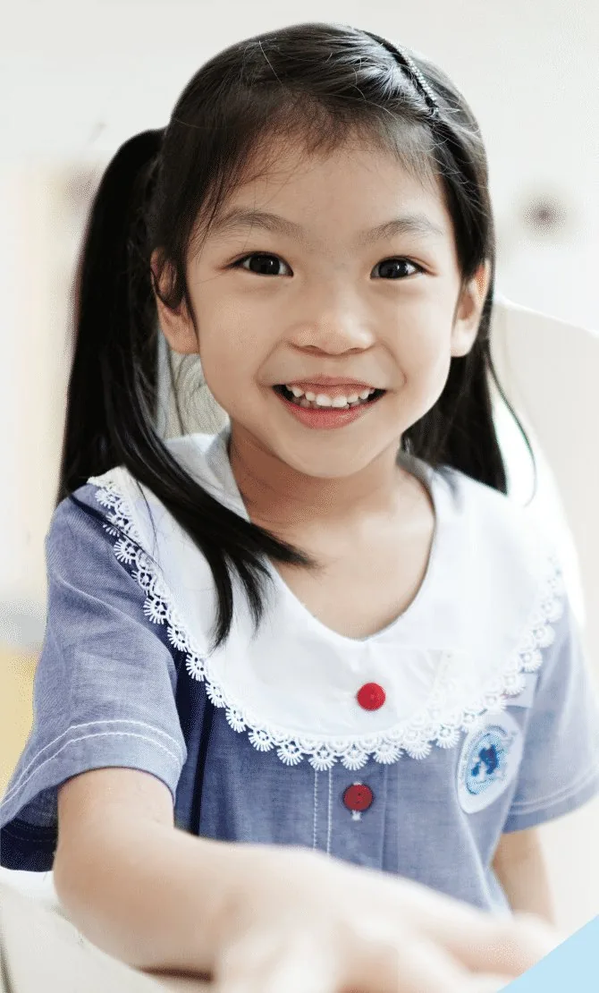 Smiling Q-dees student in uniform